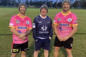 Junee captain-coach Daniel Foley and assistant Damian Willis show off the pink jumpers the Diesels will wear against Brothers on Saturday, alongside the late Rick Keast's brother Jason Ferrario. Picture by Lisa Diggins