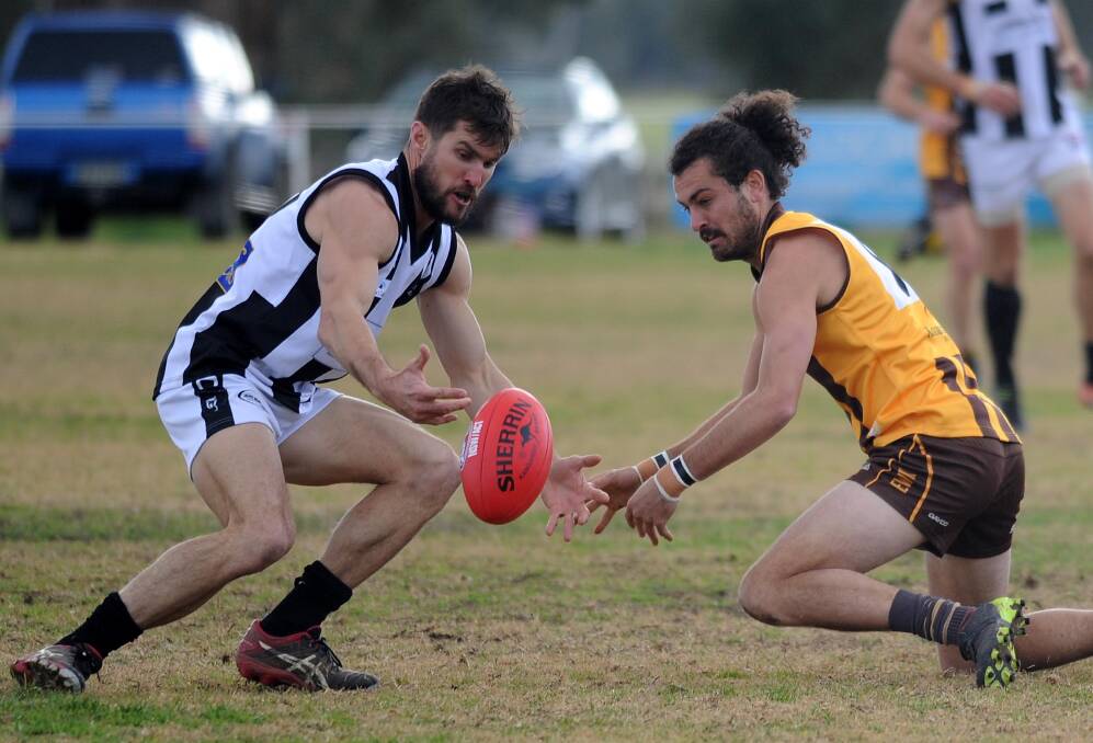 UP FOR GRABS: The Rock-Yerong Creek captain-coach Tom Yates and East Wagga-Kooringal's Brocke Argus scrap for the ball in the Farrer League game at Gumly Oval on Saturday. Picture: Laura Hardwick