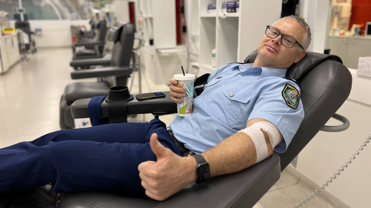 Tumut detective inspector Josh Broadfoot enjoys a pot-donation milkshake. Wagga Lifeblood needs 50 extra donations a week this flu season. Picture by Conor Burke