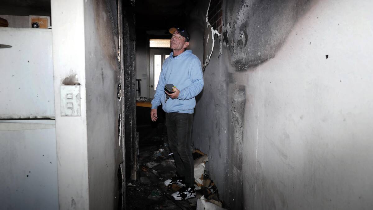 Jason 'DJ Rossi' Ross surveys the fire damaged remains of his Crampton Street townhosue. He's been left devastated by the fire but feels 'blessed by the community support. Picture by Les Smith