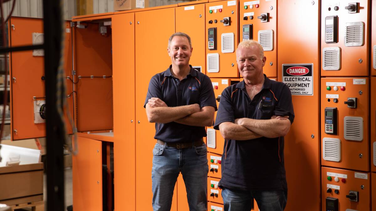 Andrew Dwyer and Adrian Burton with a switchboard similar to the one used on Menindee Water Treatment Plant. Picture by Madeline Begley