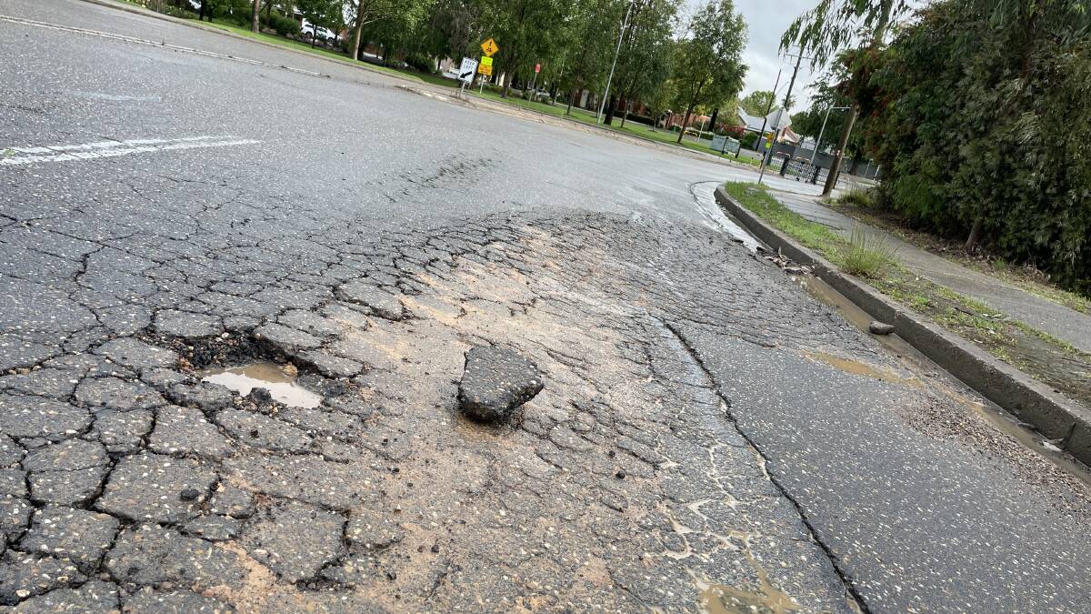 A perfect chunk of Wagga road sat beside the pothole from whence it came on Ivan Jack drive at the Wollundry Lagoon earlier this month. Picture by Conor Burke