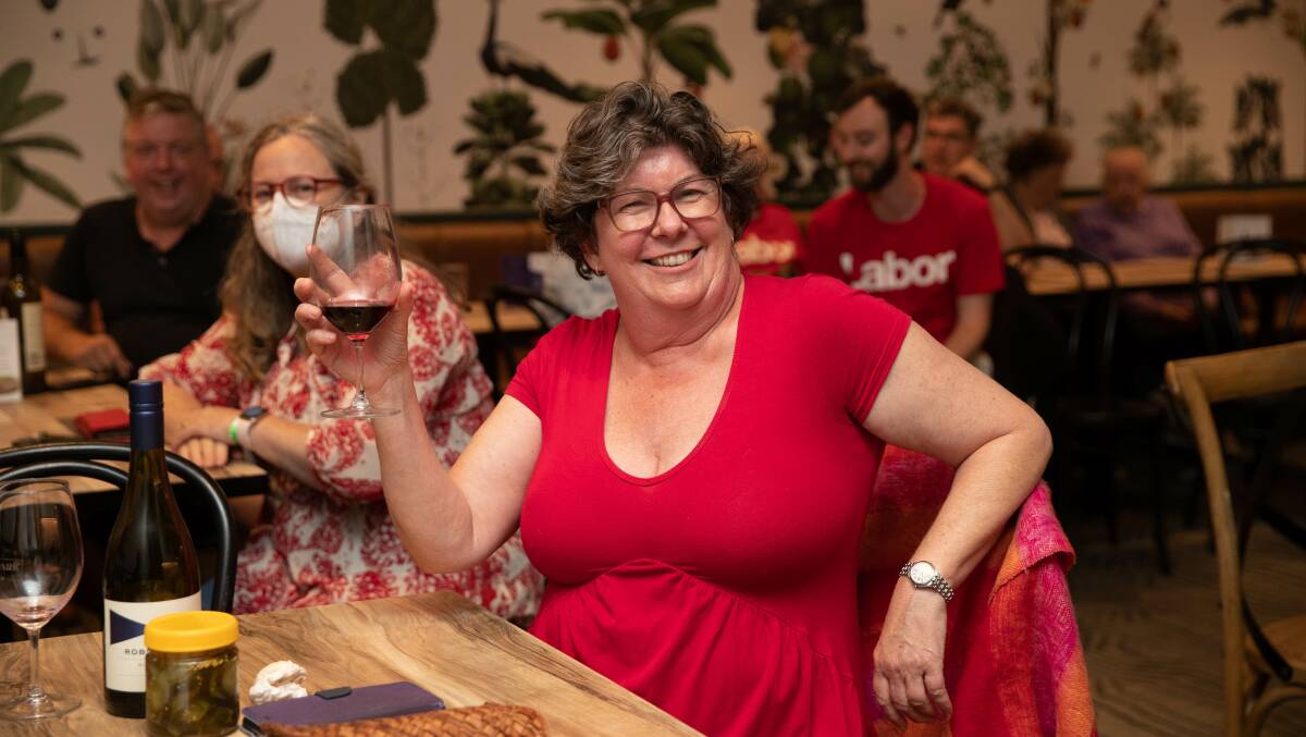 Keryn Foley enjoying a hard-earned glass of red on election night after her party swept to power and she polled strongly in the seat of Wagga. Picture by Madeline Begley