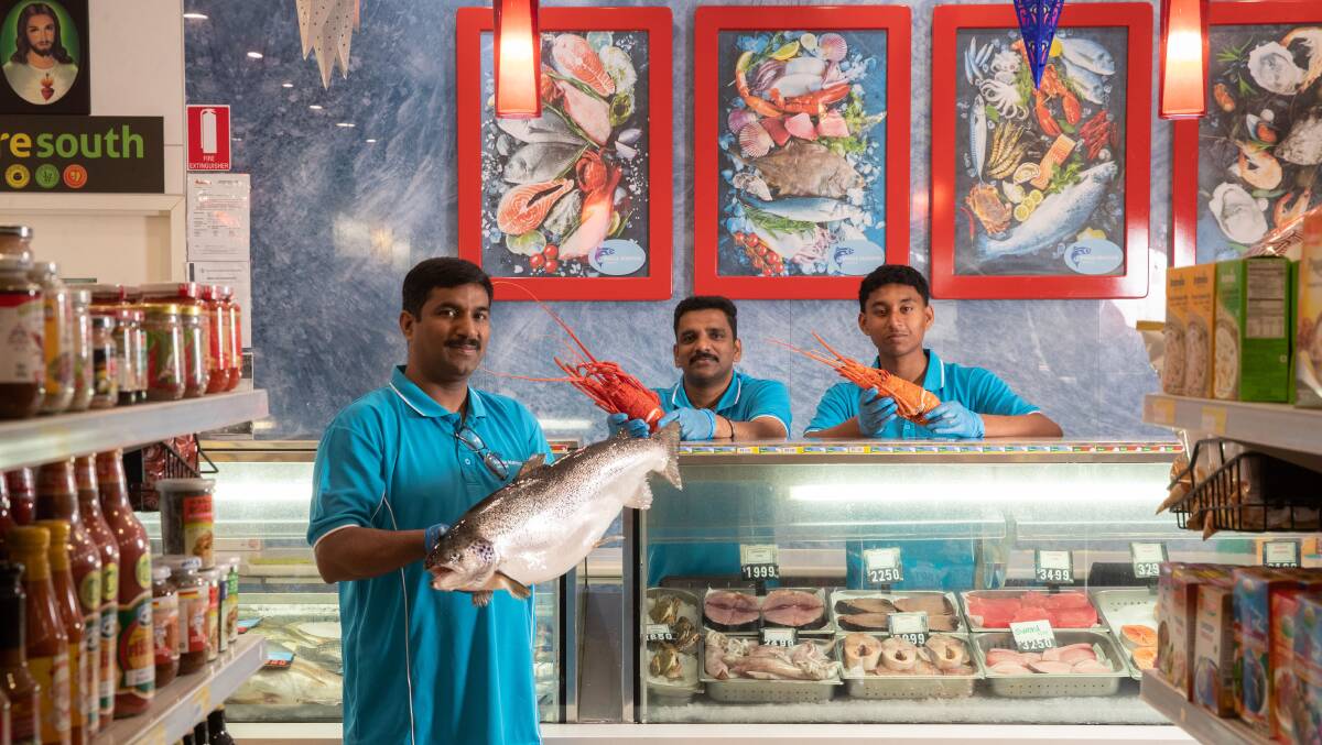 Wagga Seafood Market proprietor Roji Cherian, team leader Loges Palani and staff member Harry Thomas are ready for the Christmas rush. Picture by Madeline Begley 