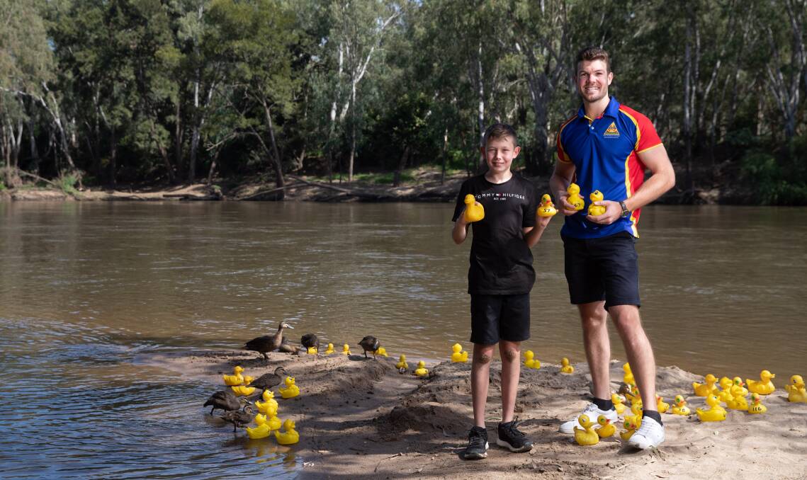 Organiser Zachary Morden-Jones, alongside son Chayse, 11, and some real and less real ducks all gearing up for the return of the Mighty Murrumbidgee River Duck Race. Picture by Madeline Begley