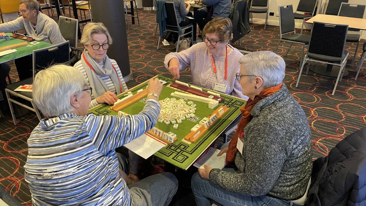 Sue Kingston (left to right) winning a hand against fellow mahjong players Helen Wild, Pat Morey and June Brayne. Picture: Tim Piccione