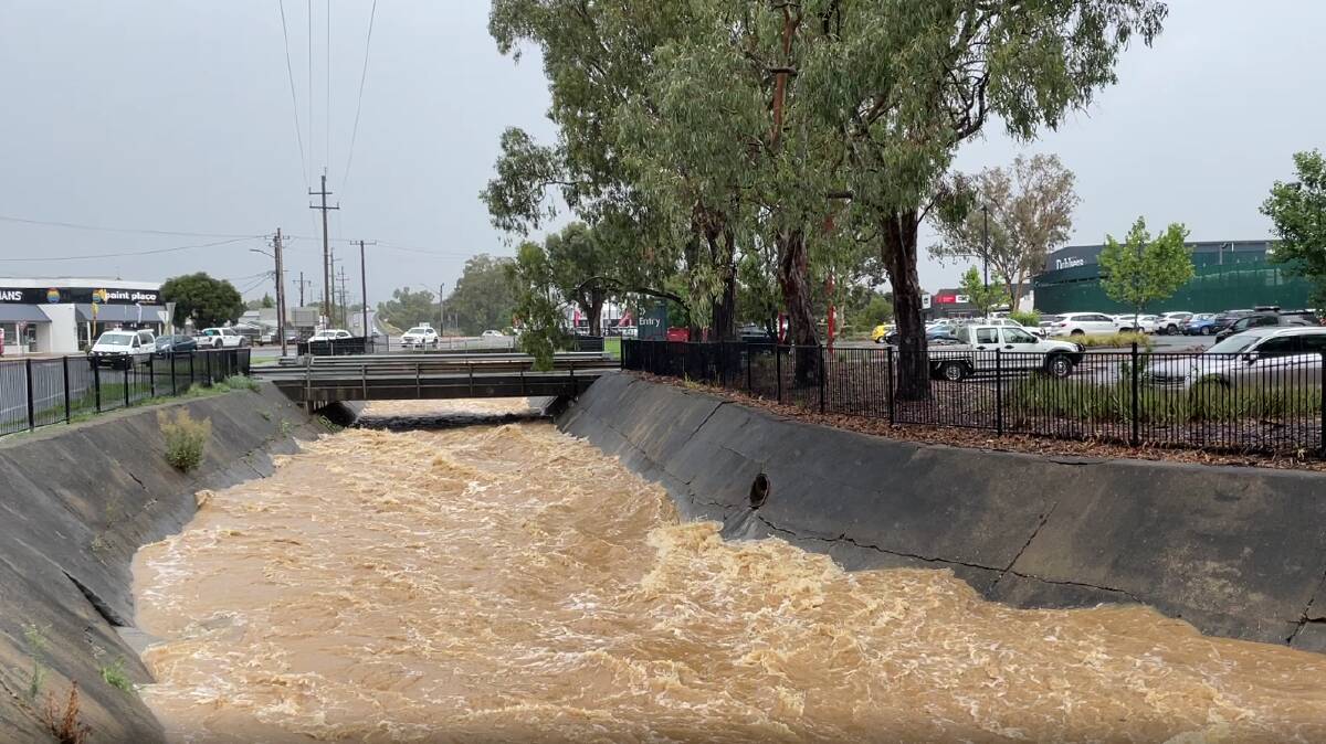 A stormwater drain along Pearson Street outside Bunnings surges as Wagga receives heavy rainfall on Monday. Picture by Madeline Begley
