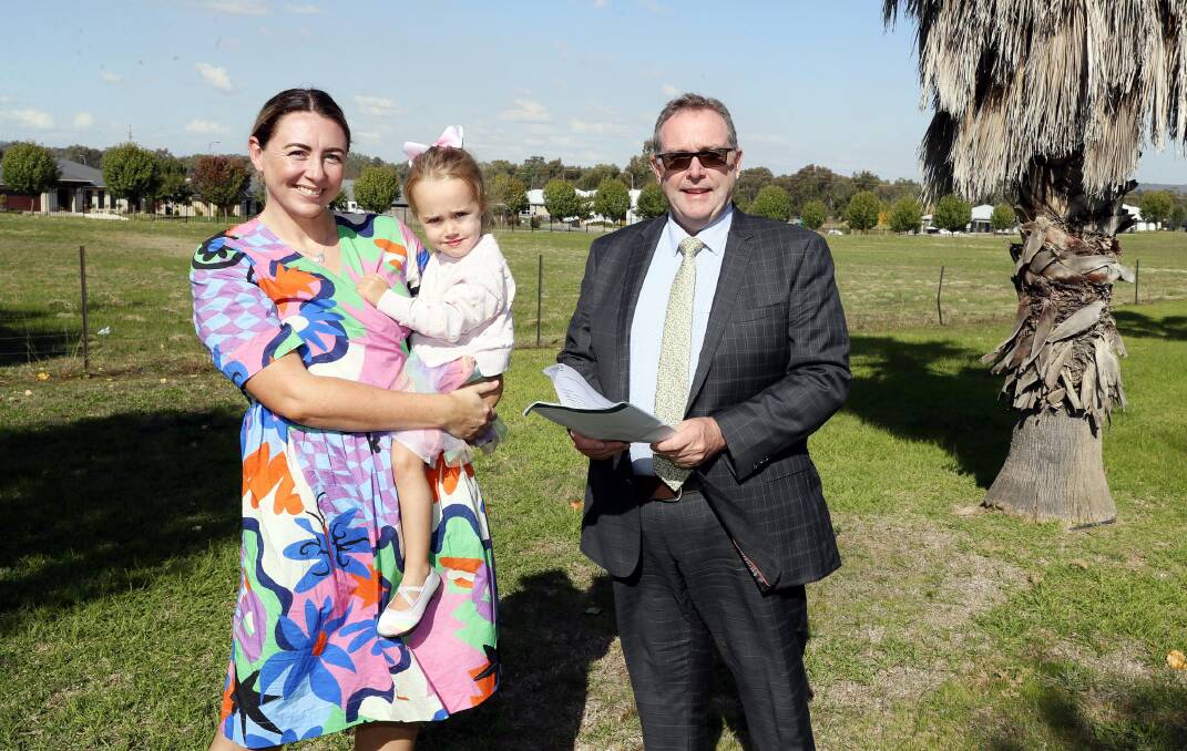 Director of Catholic education Andrew Watson with Jess De Jong and her daughter Rose, 3, on the proposed new site for the school. Picture by Les Smith
