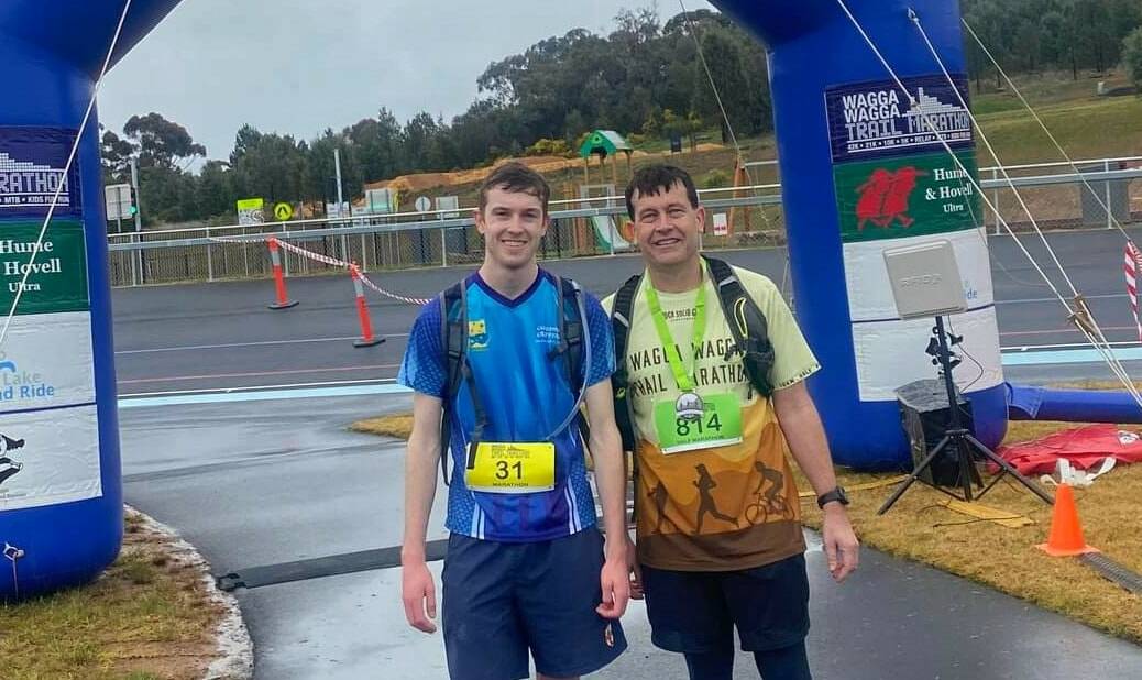 TOUGH ASK: Caleb Addison (left) braved the wet to run the full Wagga Trail Marathon on Saturday while father Brad (right) completed the half marathon. Picture: Contributed