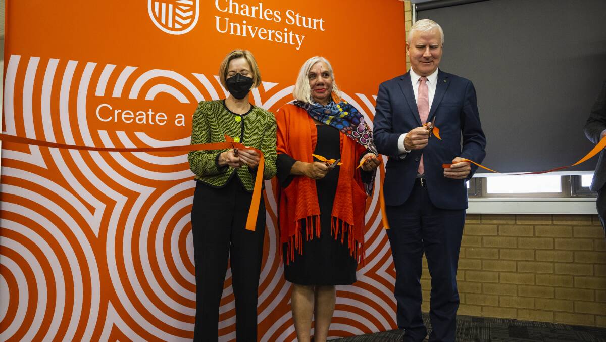 CSU Vice-Chancellor Professor Renée Leon, Aunty Cheryl Penrith and Michael McCormack cut the ribbon at the opening of the CSU regional archives on Tuesday. Photo by Ash Smith