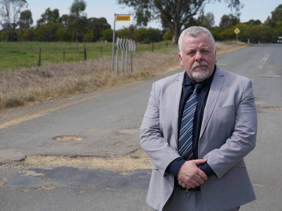 Wagga councillor Richard Foley near a mega-pothole taking up almost a whole lane on Edison Road at East Wagga. Picture by Andrew Mangelsdorf