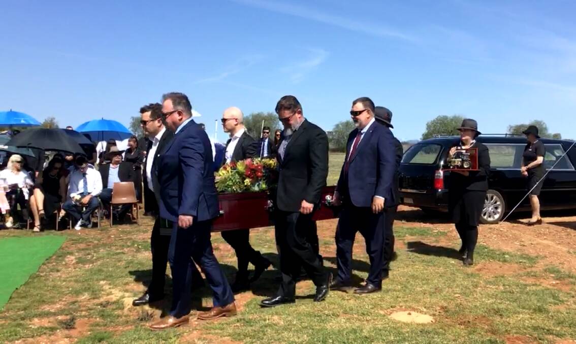 Pallbearers carry Trevor Breen's coffin to the burial site at the Lake Cargelligo Lawn Cemetery on Thursday. Picture supplied