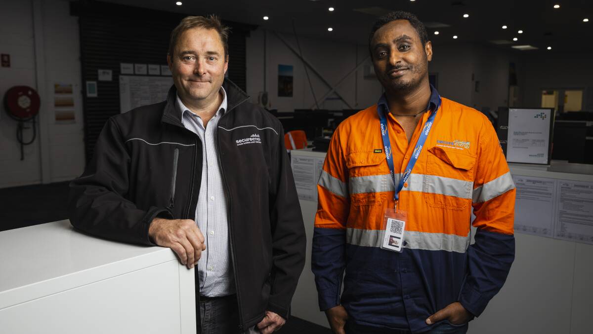 SecureEnergy project training manager Chris Jones with project engineer Ashenafi Woldehawariat at the Wagga office on Friday. Picture by Ash Smith