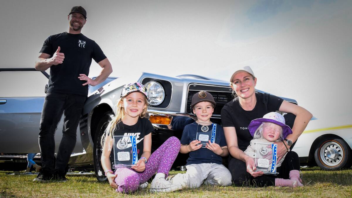 Lee and Amanda Shoemark with children Chloe, 6, Brayden, 5, and Ella, 1, and the three trophies their 1971 HQ GTS sedan won at the family's first ever car show. Picture by Bernard Humphreys 