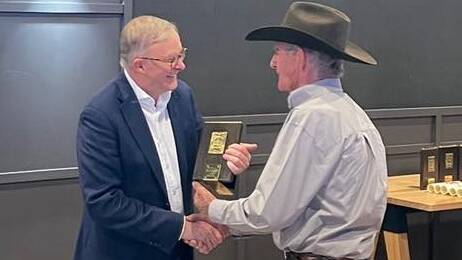 Australian prime minister Anthony Albanese presents Cootamundra cowboy Bob Holder with a Good Australian award at the Mount Isa Rodeo last week. Picture contributed