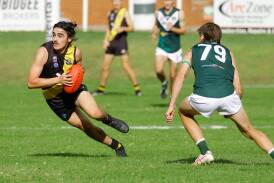 Wagga Tigers midfielder Will Kirkup works his way past Coolamon's Jack Rudd. The Tigers went down to the Hoppers at Kindra Park on Sunday. Picture by Bernard Humphreys