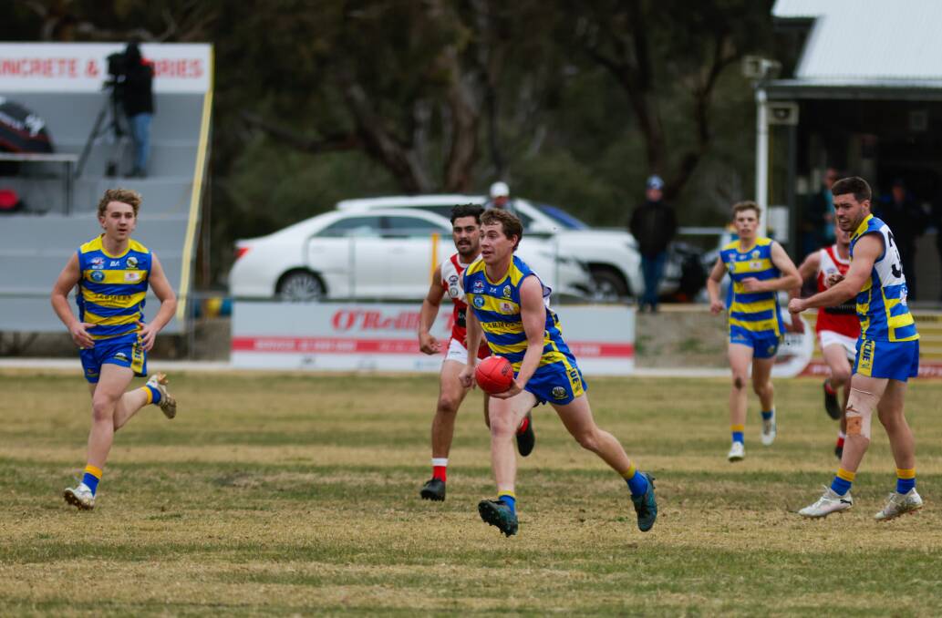 MCUE's Ethan Schiller looks to handball during the Goannas loss to Collingullie-Wagga at Mangoplah Sportsground. Picture by Tom Dennis