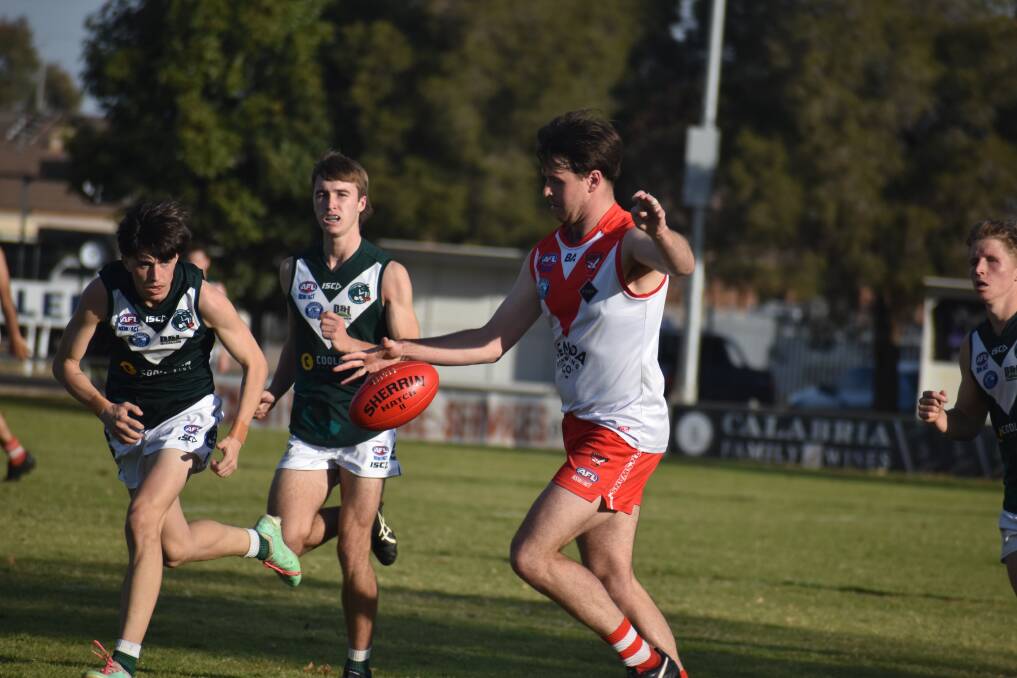 Griffith's Henry Delves gets a kick away during the Swans 14-point loss to Coolamon at Exies Oval. Picture by Liam Warren
