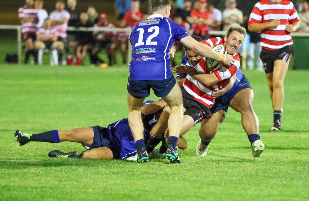 CSU's Cameron Thomas is brought down in a tackle during the twilight clash between the Reddies and Waratahs. Picture by Les Smith