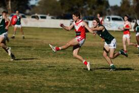Collingullie-Wagga midfielder Chad Fuller gets a kick away while under pressure during the Demons clash with Coolamon at Crossroads Oval. Picture by Tom Dennis