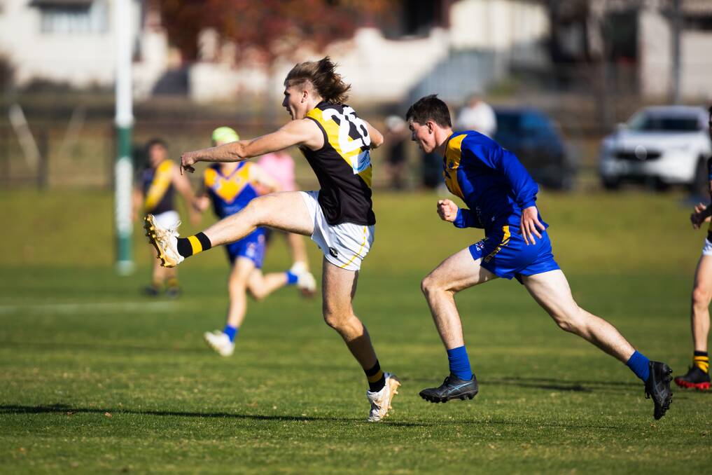 Wagga Tigers' Cooper Pavitt gets a kick away while under pressure from Narrandera's James Smith. Picture by Ash Smith