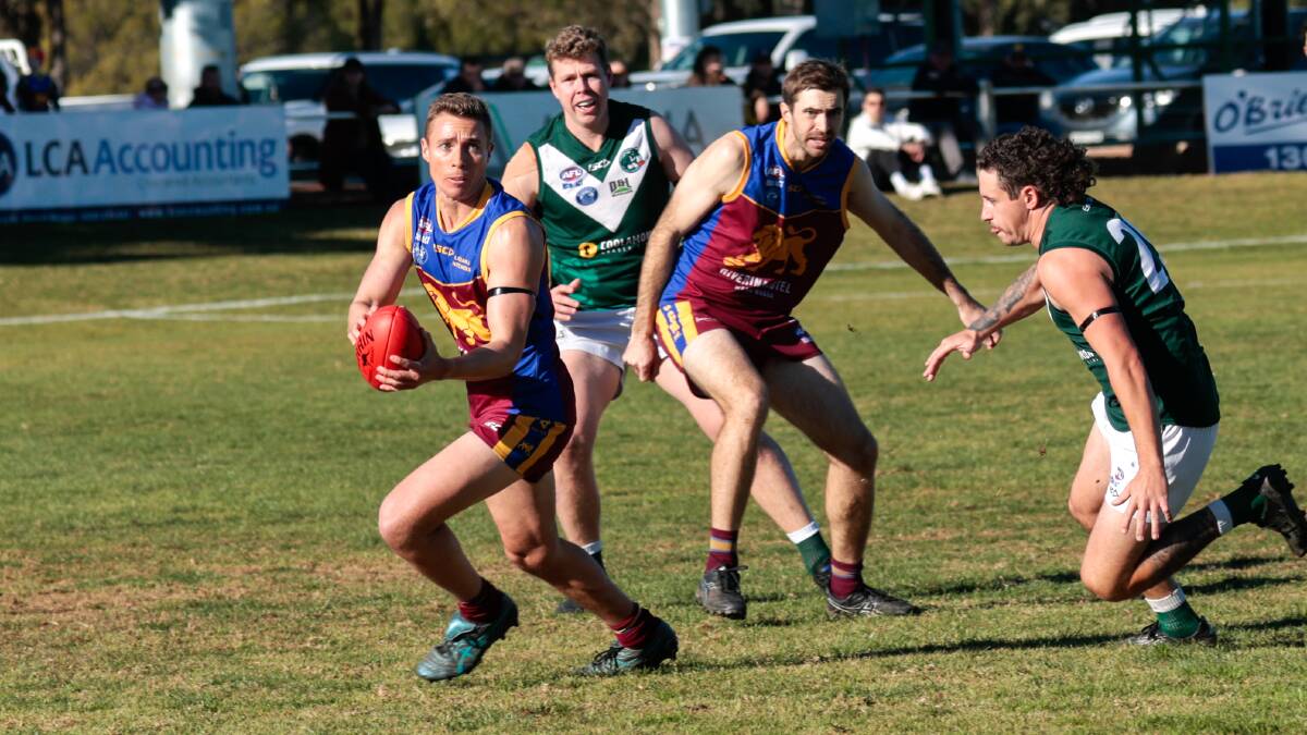 GGGM defender Zac Burhop looks to work past Coolamon's Kyle Woods during the clash between the Hoppers and Lions at Kindra Park. Picture by Bernard Humphreys