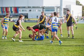 MCUE midfielder Lachy Kendall tackles Wagga Tigers' Tommy McCoullough during the clash between the Goannas and Tigers at Robertson Oval. Picture by Tom Dennis