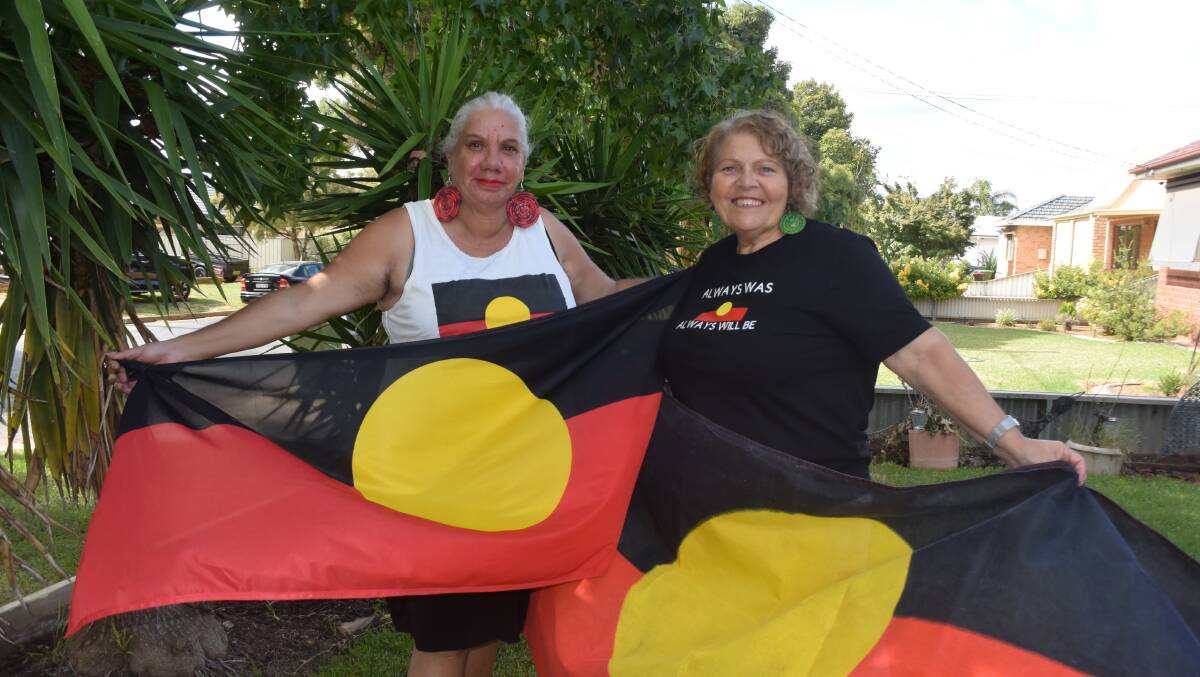Cheryl Penrith and Mary Atkinson pictured with the Aboriginal flag after it was freed from copyright last year. File picture