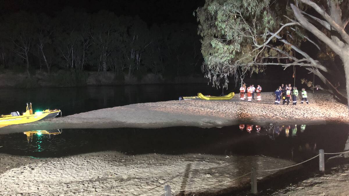 Emergency service workers gather on Wagga Beach in search of a man feared missing in the Murrumbidgee River. Picture by Georgia Rossiter