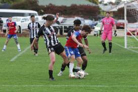 Liam Vickers takes on Wanderers' Nathan Singh Maxwell Prest. Picture by Tom Dennis
