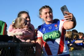 Newcastle's Sheridan Gallagher treats young fans to a sideline selfie. NRLW trial game at Wagga Wagga. Canberra Raiders v Newcastle Knights. Picture by Bernard Humphreys