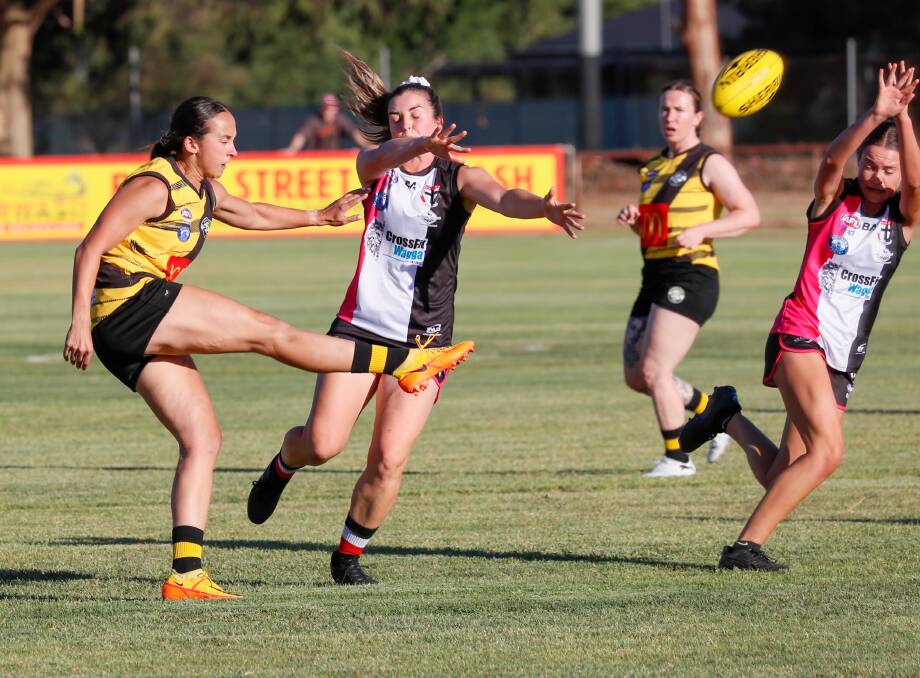 Wagga Tigers Biana Ross gets a kick past Meg Davies. Picture by Les Smith