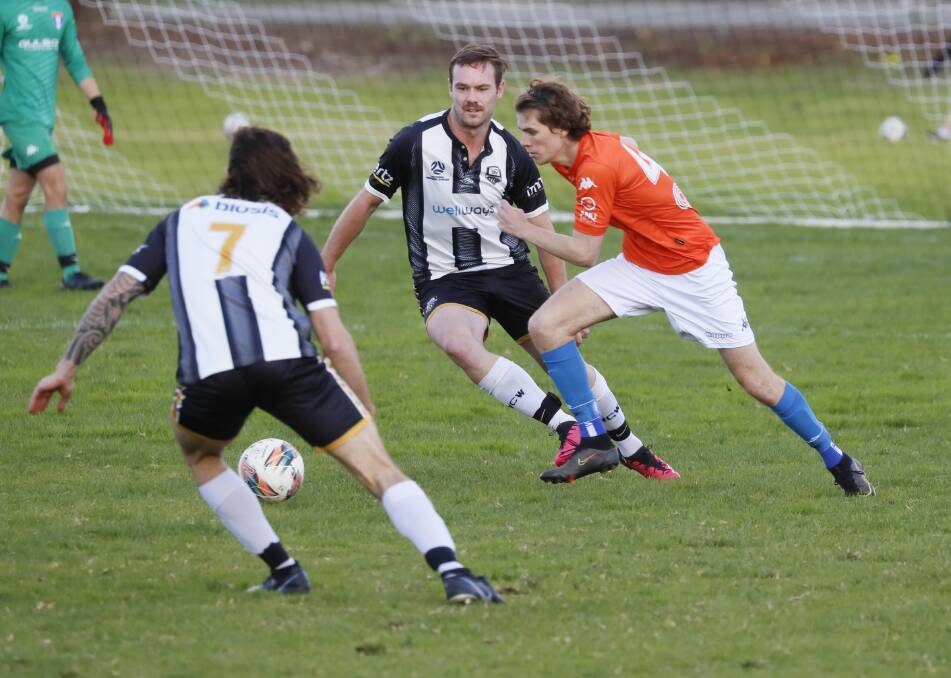 Jake Ploenges and Charlie Witt converge on the ball during Wanderers last meeting with ANU at home. Picture by Les Smith