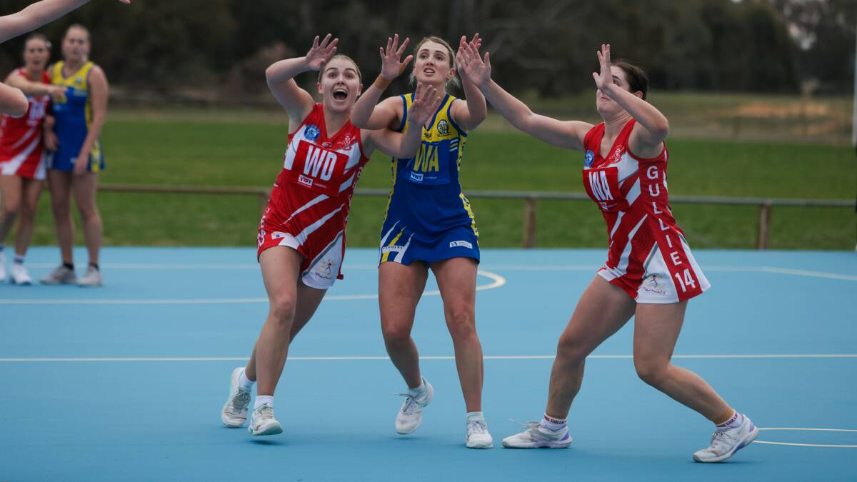 MCUE's Mikaela Cole takes on Collingullie-Wagga's Abbey Grant and Tameka Scott for a high ball during the Goannas win on Saturday. Picture by Tom Dennis