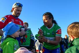 Leeton's Ua Ravu signs a ball for local supporters after the Canberra Raiders NRLW trial against Newcastle Knights. Picture by Bernard Humphreys