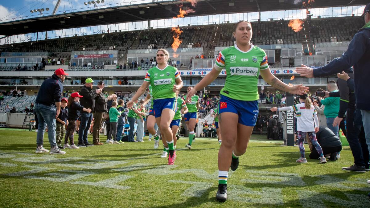 Canberra Raiders Tommaya Kelly-Sines and Ashleigh Quinlan run out on into Canberra Stadium in 2023. Picture by Elesa Kurtz