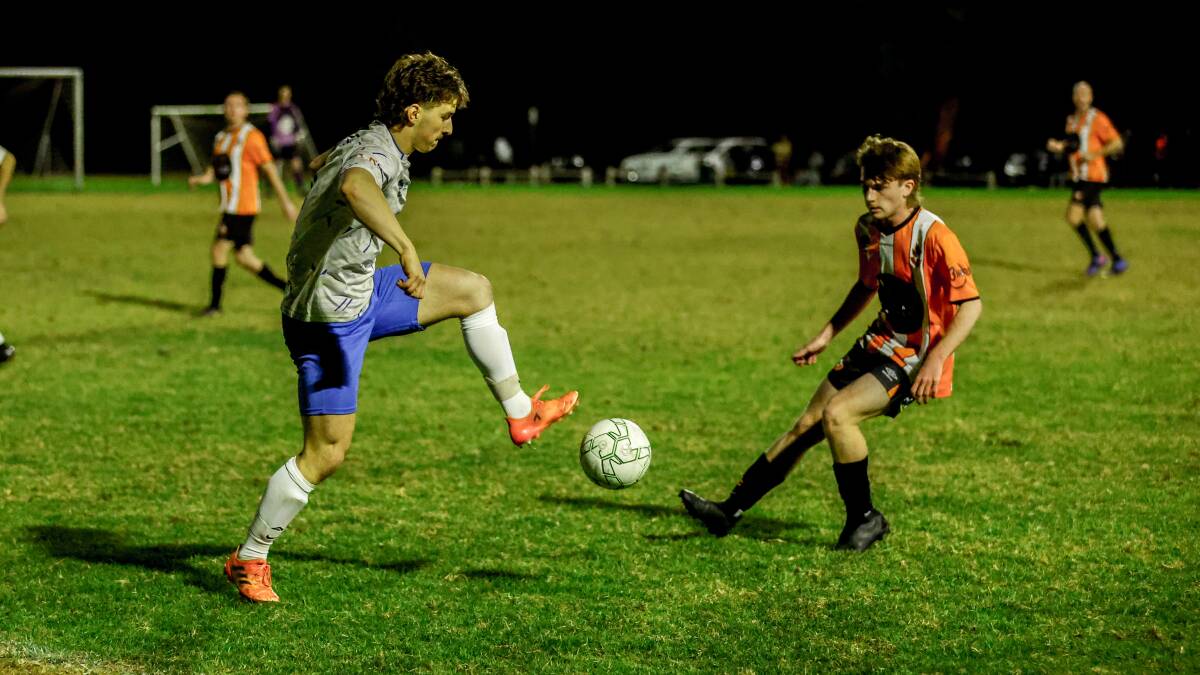Tolland's Adam Bevis and Wagga United's Ben Mitchell compete for the ball during Toland's 6-1 win. Picture by Bernard Humphreys