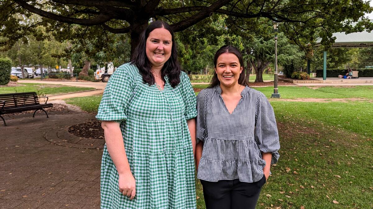 Emma Corbett and Kim Parker, from Wagga City Council's events team, announce the new funding pool at the Victory Memorial Gardens on Monday. Picture by Dan Holmes.