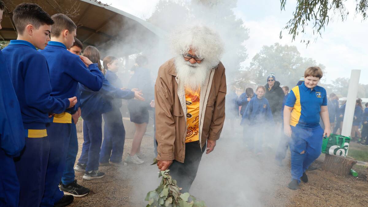 Uncle Pat Connolly performs a smoking ceremony at Lake Albert Public School's new yarning circle. Picture by Les Smith