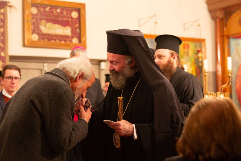 Archbishop Makarios offers blessing to a parishioner at Dormition of Our Lady Orthodox Church. Picture by Madeline Begley