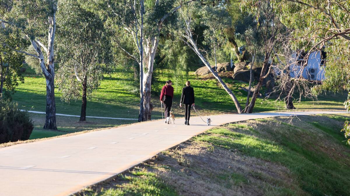 The riverside walking track along the Murrumbidgee River is sunlit by day, and pitch black by night. Picture by Les Smith