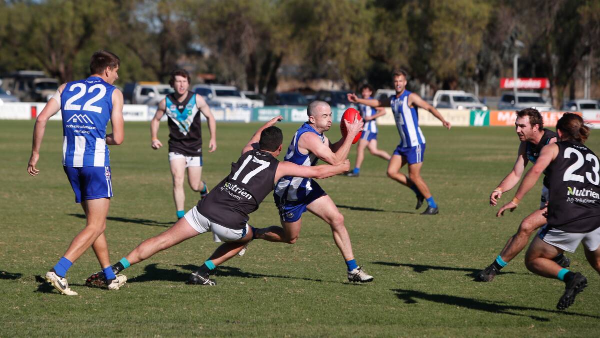 Temora's Jimmy Kennedy looks to burst through the tackle of Northern Jets' Nate Doyle in the Farrer League game at Nixon Park on Saturday. Picture by Tom Dennis