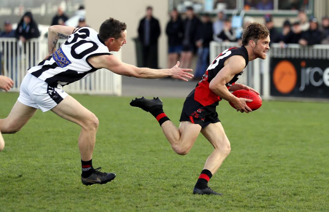 Marrar's Will Keogh gets away from The Rock-Yerong Creek's Scott Wolter in the Farrer League grand final on Saturday. Picture by Les Smith