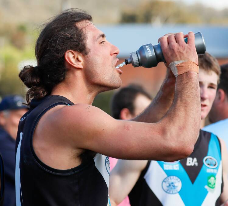 Mitch Haddrill takes a well-earned drink during a break in Saturday's Farrer League grand final at Robertson Oval. Picture by Les Smith