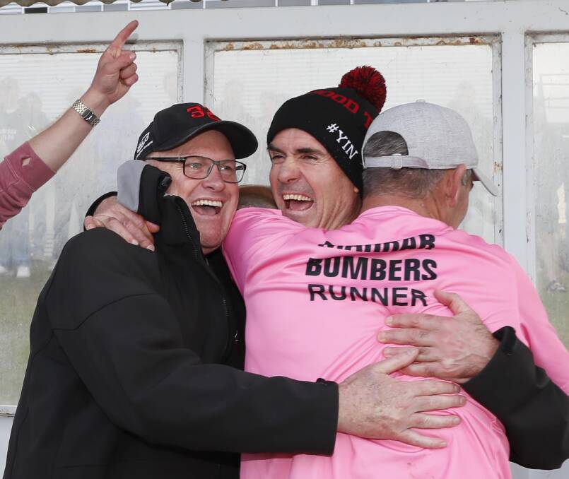 Marrar coach Shane Lenon celebrates at the final siren with brother Brett and Paul Jenkins. Picture by Les Smith