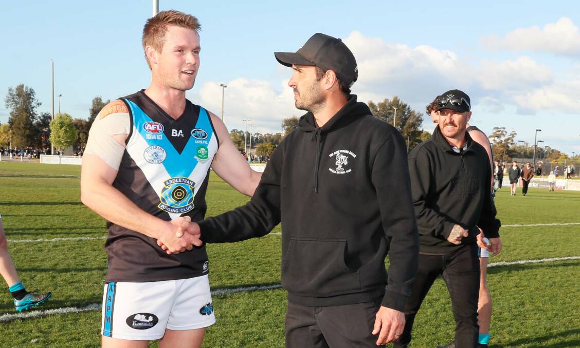 Northern Jets coach Jack Harper shakes the hand of The Rock-Yerong Creek co-coach Heath Russell after the final siren in Saturday's grand final. Picture by Les Smith