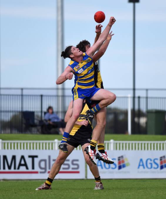HIGH FLYERS: Mangoplah-Cookardinia United-Eastlakes' Matt Collins contests with Wagga Tigers' John Anstee in the game at Robertson Oval on Saturday. Picture: Laura Hardwick