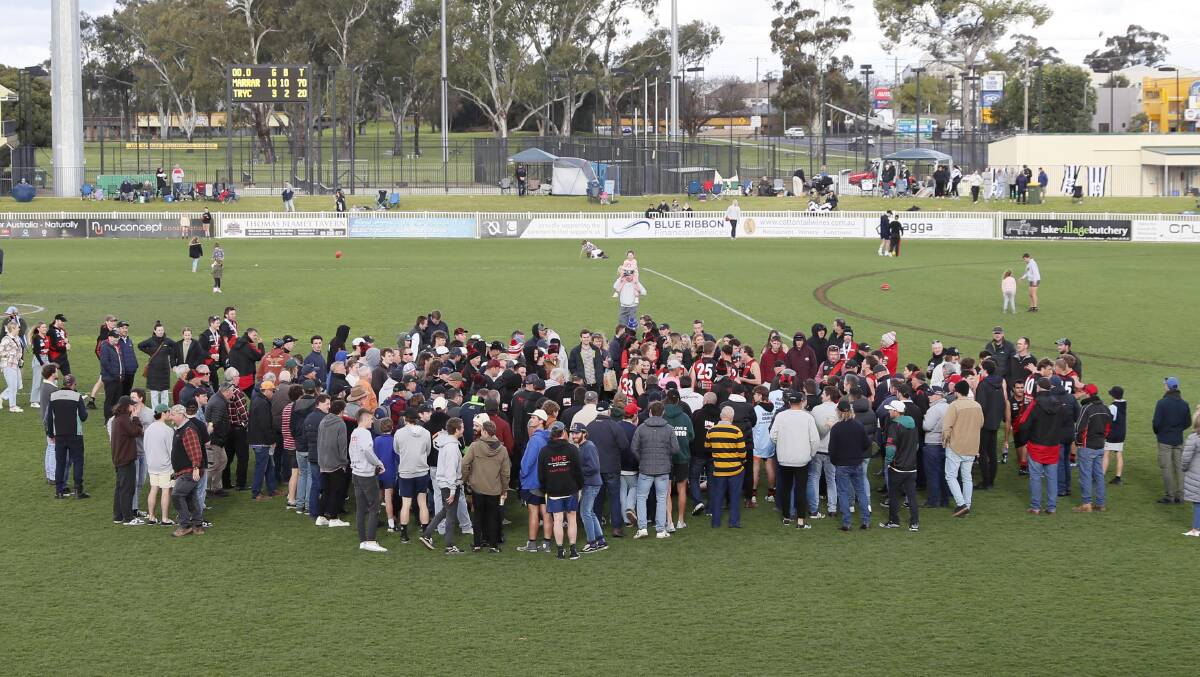 The huddle around Shane Lenon's three-quarter-time address in Saturday's grand final. Picture by Les Smith