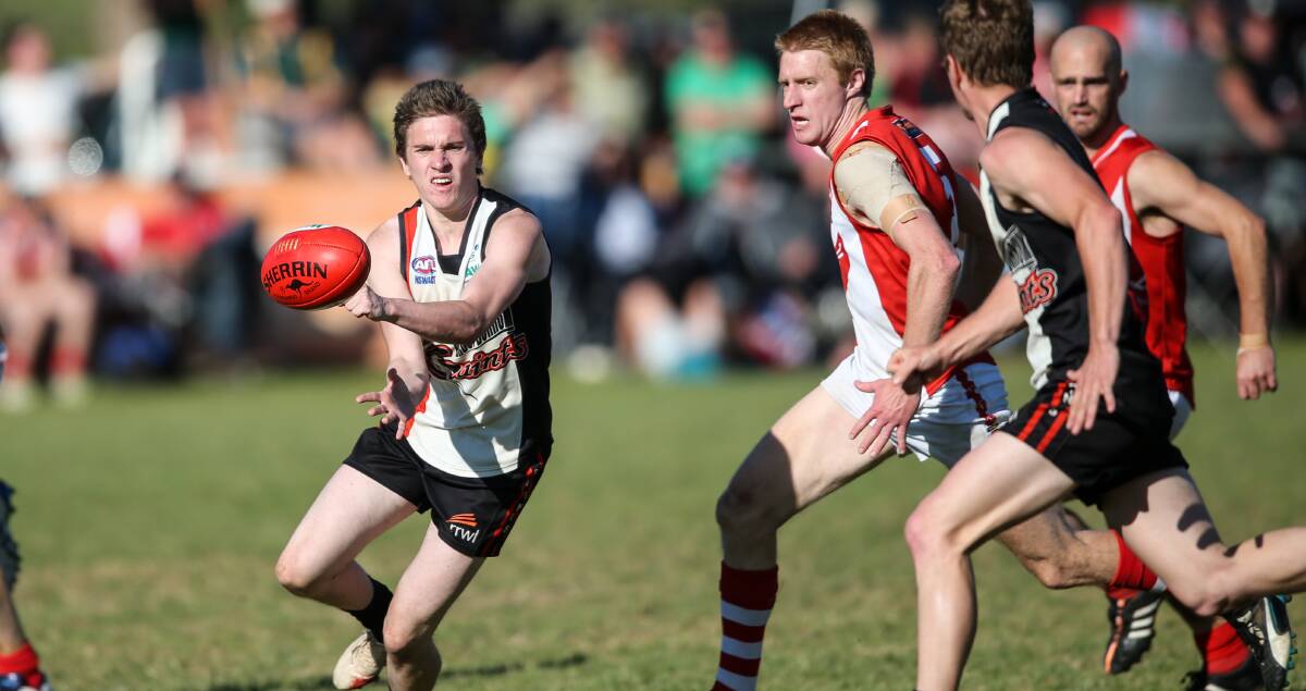 QUICK HANDS: Brocklesby-Burrumbuttock's Josh McCudden and Henty's Jimmy Ellis do battle in the Hume League grand final at Walbundrie on Saturday. Picture: The Border Mail