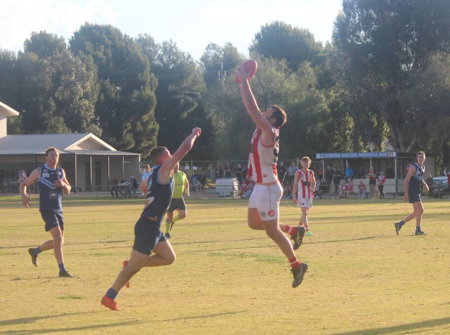 Charles Sturt University's Trent Cohalan marks in the dying minutes and goes back to kick the sealer against Barellan at Barellan Sportsground on Saturday. Picture by Matt Malone